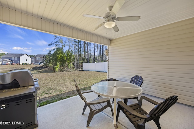 view of patio / terrace featuring area for grilling, outdoor dining area, fence, and ceiling fan