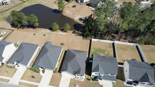 drone / aerial view featuring a residential view and a water view