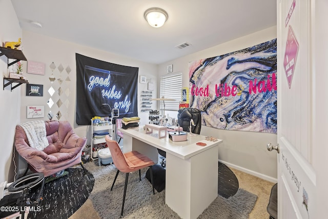 carpeted home office featuring visible vents and baseboards