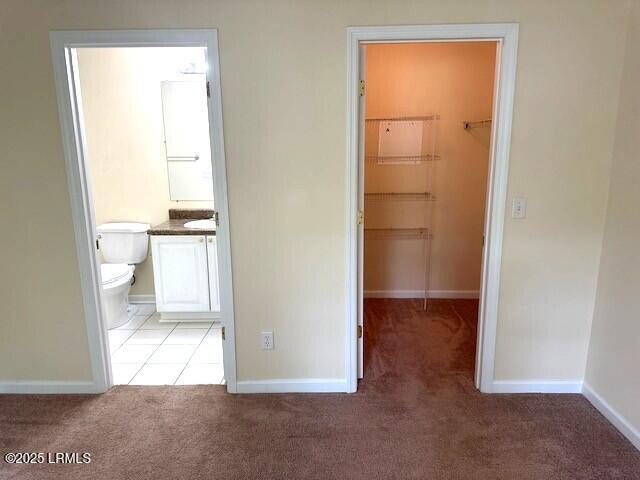100 Kensington Blvd Unit 1315, Bluffton, SC 29910 - unfurnished bedroom featuring a walk in closet, carpet floors, a closet, and ensuite bath