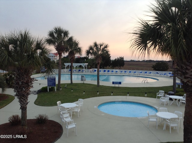 18 Sand Dollar Ct, Harbor Island, SC 29920 - pool at dusk featuring a yard and a patio