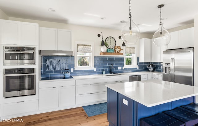 18 Sand Dollar Ct, Harbor Island, SC 29920 - kitchen featuring sink, appliances with stainless steel finishes, white cabinets, a kitchen island, and decorative light fixtures