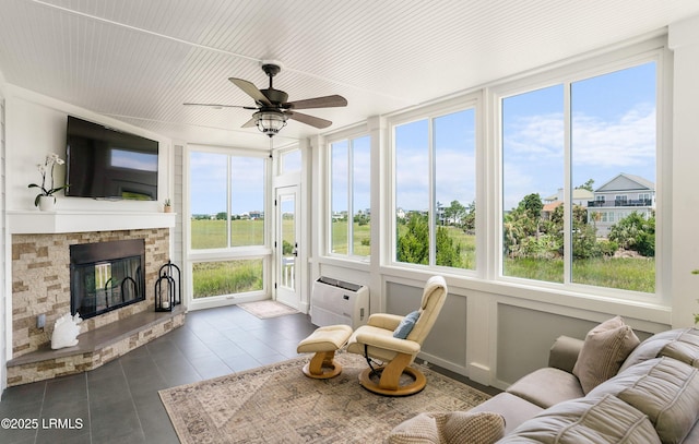 18 Sand Dollar Ct, Harbor Island, SC 29920 - sunroom / solarium featuring ceiling fan and a stone fireplace
