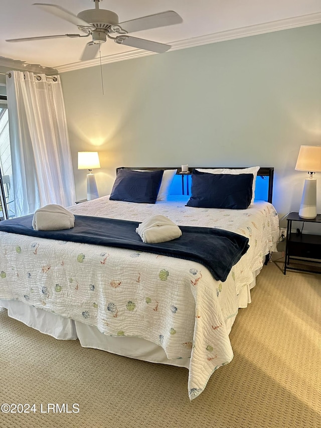 bedroom featuring ornamental molding, carpet floors, and ceiling fan