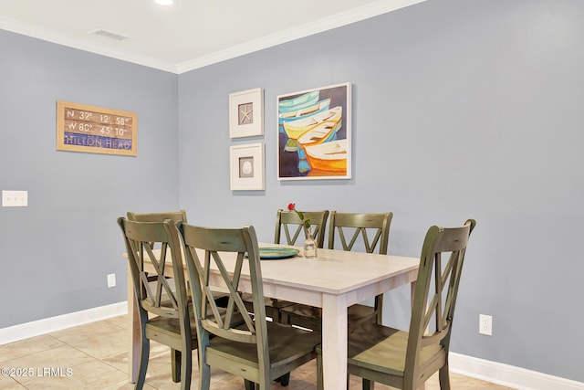 tiled dining room featuring crown molding