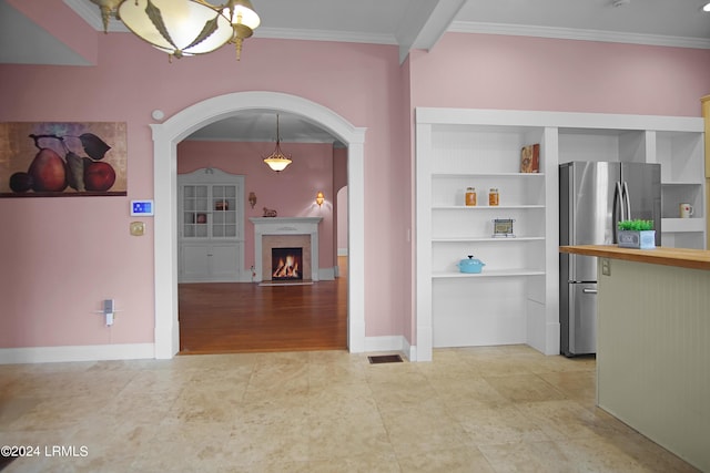 interior space featuring crown molding and a chandelier