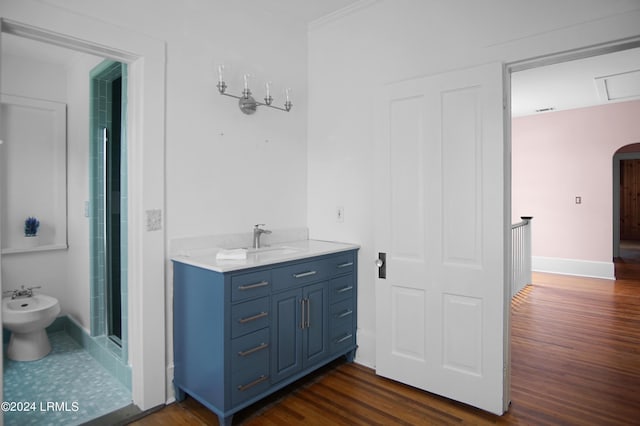 bathroom with walk in shower, a bidet, ornamental molding, vanity, and hardwood / wood-style floors