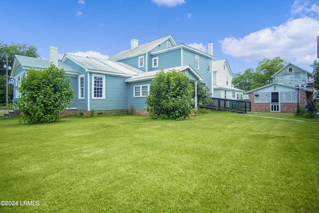 rear view of house with a yard