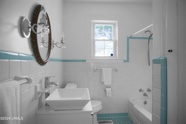 full bathroom with tile walls, vanity, bathtub / shower combination, and toilet