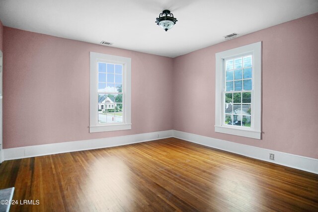 spare room featuring wood-type flooring