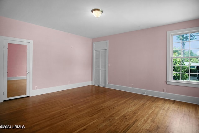 spare room with hardwood / wood-style floors