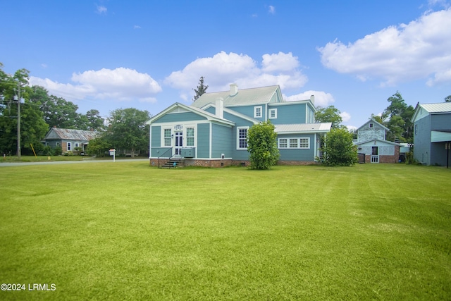 back of property featuring a lawn