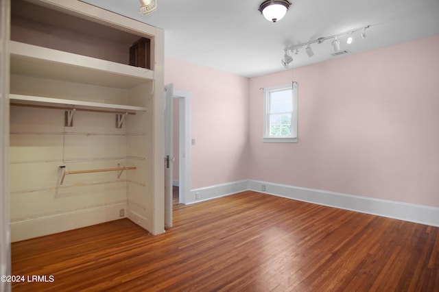 unfurnished bedroom featuring wood-type flooring and a closet