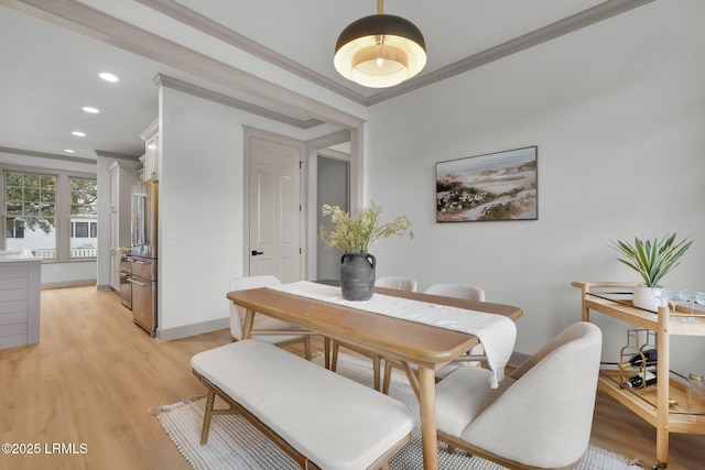 dining area with light wood-style floors, baseboards, crown molding, and recessed lighting