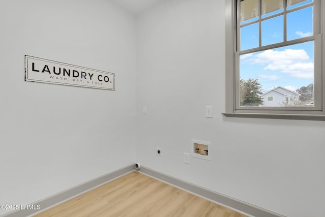 washroom with laundry area, washer hookup, wood finished floors, baseboards, and electric dryer hookup