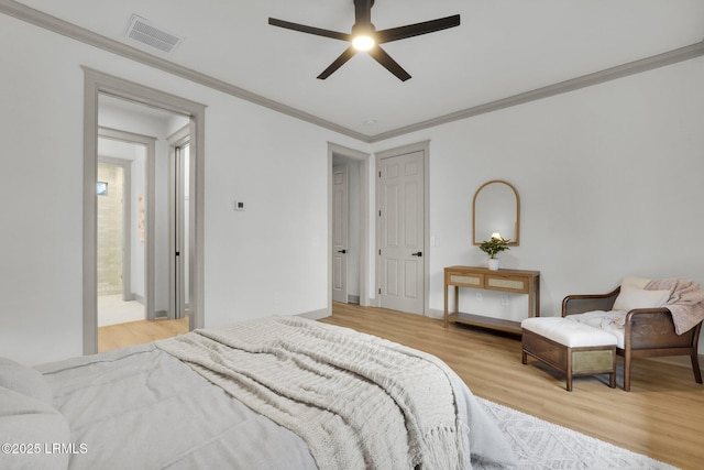 bedroom with light wood-style flooring, visible vents, baseboards, a ceiling fan, and ornamental molding