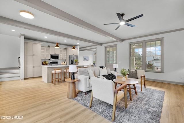 living room with ceiling fan, recessed lighting, light wood-style floors, stairs, and beam ceiling