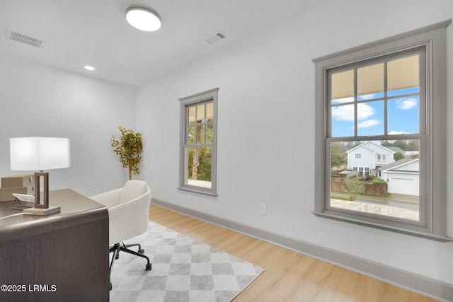 home office with recessed lighting, visible vents, light wood-style flooring, and baseboards