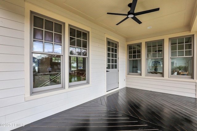 unfurnished sunroom featuring ceiling fan