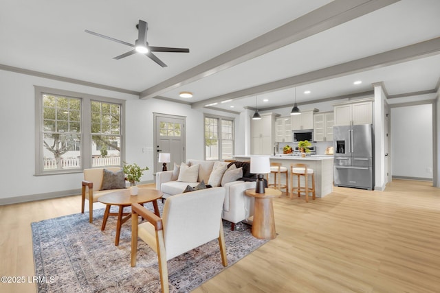 living area featuring light wood finished floors, baseboards, a ceiling fan, beamed ceiling, and recessed lighting