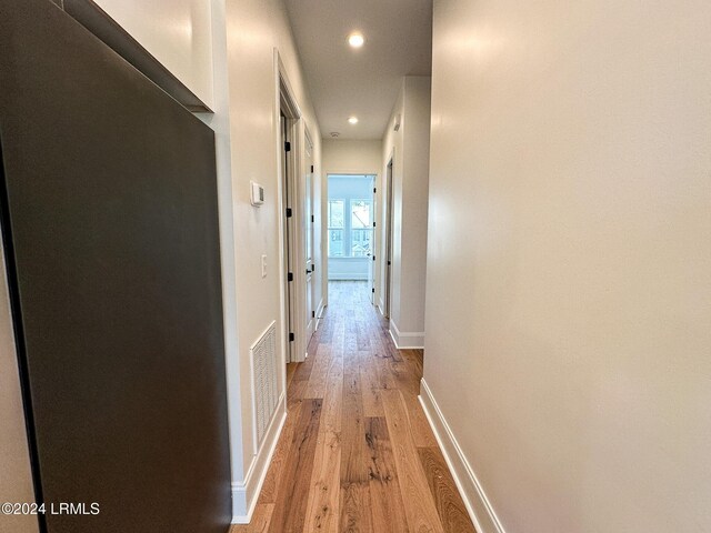 corridor with light wood-type flooring