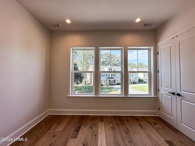 spare room with hardwood / wood-style floors