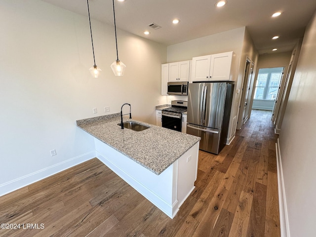 kitchen featuring sink, white cabinetry, hanging light fixtures, stainless steel appliances, and kitchen peninsula