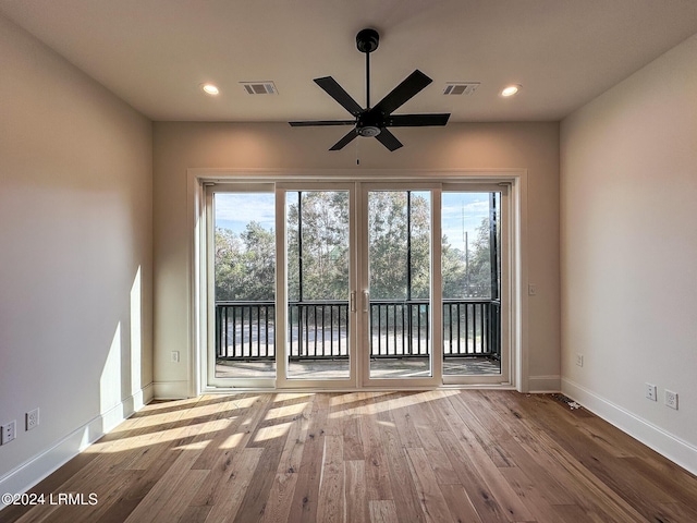 unfurnished room with ceiling fan and light hardwood / wood-style floors