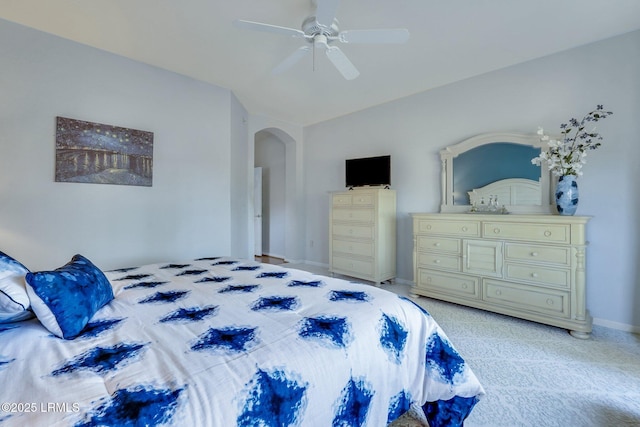 bedroom with lofted ceiling, light colored carpet, and ceiling fan