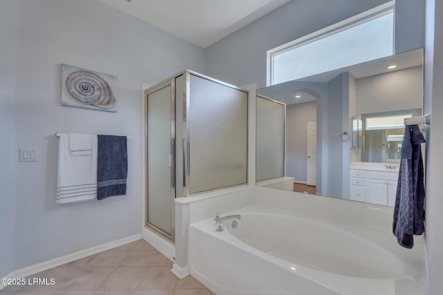 bathroom featuring tile patterned floors, vanity, independent shower and bath, and a wealth of natural light