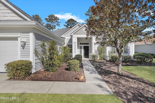 view of exterior entry with a garage