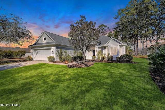 view of front facade featuring a garage and a lawn