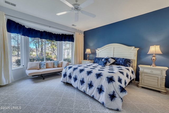 carpeted bedroom featuring ceiling fan and multiple windows