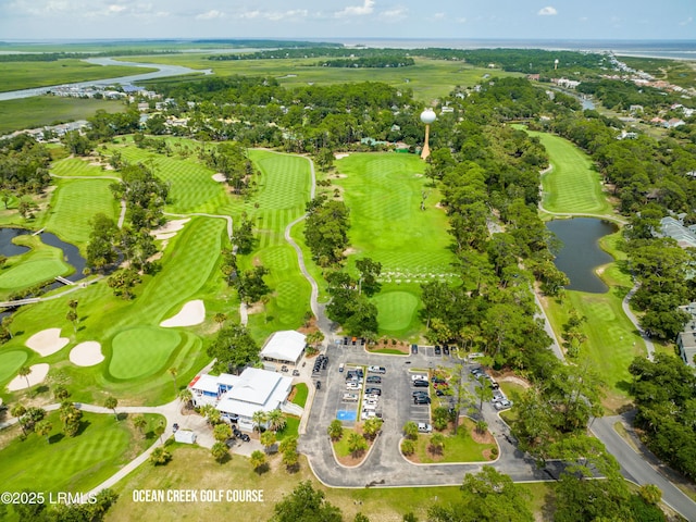 bird's eye view featuring golf course view and a water view