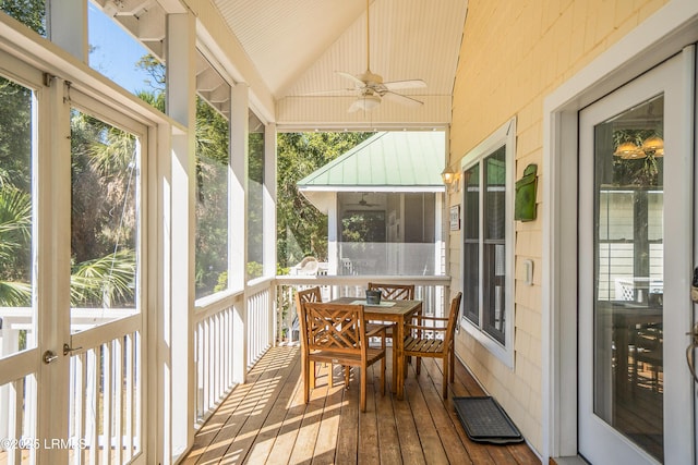 sunroom featuring outdoor dining space and a ceiling fan