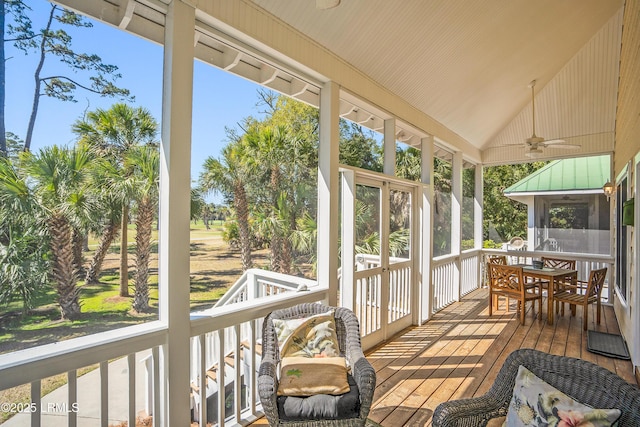 sunroom featuring outdoor dining space and ceiling fan