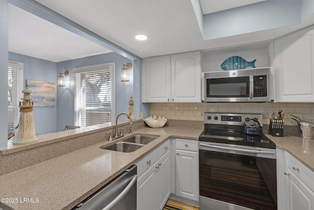 6 Lighthouse Ln Unit 963, Hilton Head Island, SC 29928 - kitchen with appliances with stainless steel finishes, white cabinetry, backsplash, and recessed lighting