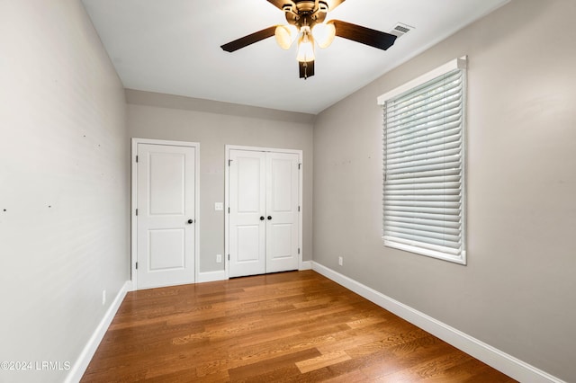 unfurnished bedroom with ceiling fan and light hardwood / wood-style flooring