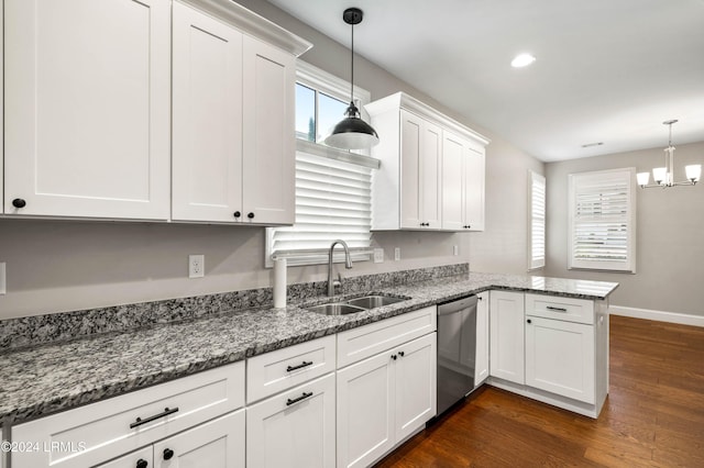 kitchen featuring decorative light fixtures, sink, stainless steel dishwasher, and kitchen peninsula