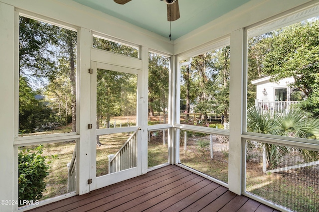 unfurnished sunroom featuring plenty of natural light and ceiling fan