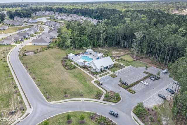 bird's eye view with a wooded view