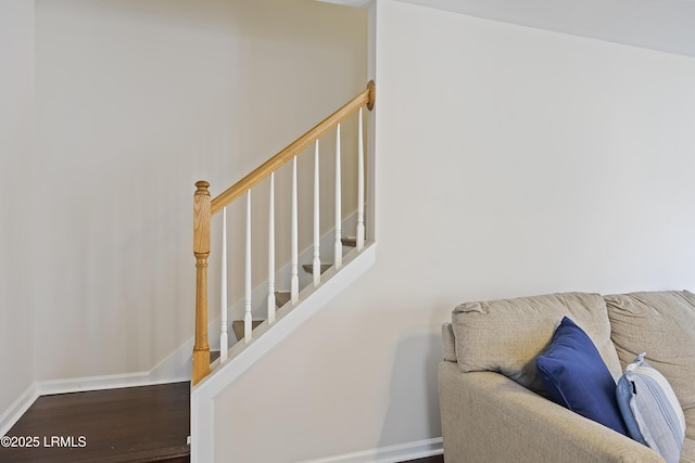 stairway with baseboards and wood finished floors