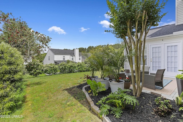 view of yard with a patio and french doors