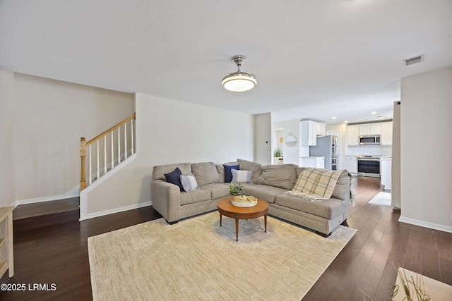 living room featuring recessed lighting, stairway, baseboards, visible vents, and dark wood-type flooring