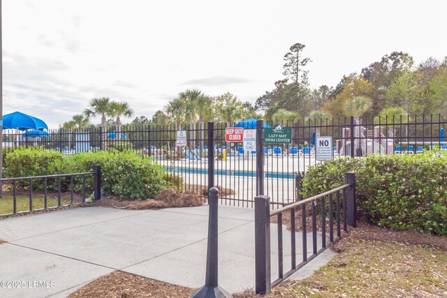 view of community featuring fence