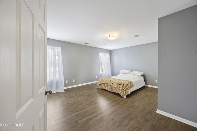 bedroom featuring baseboards, visible vents, and dark wood-style flooring