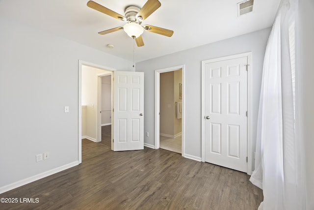 unfurnished bedroom featuring dark wood finished floors, visible vents, ceiling fan, and baseboards