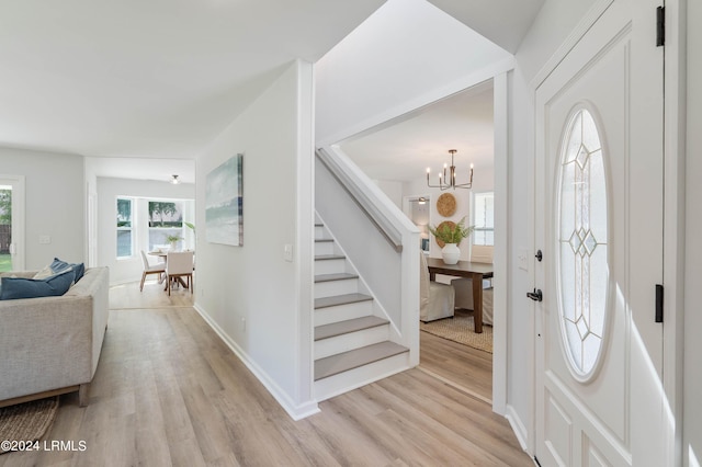 foyer featuring light hardwood / wood-style flooring and a chandelier