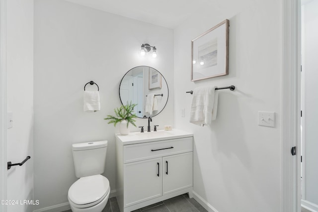 bathroom with vanity, toilet, and tile patterned flooring