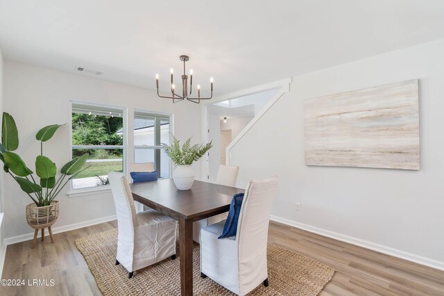 dining area featuring a notable chandelier and light wood-type flooring